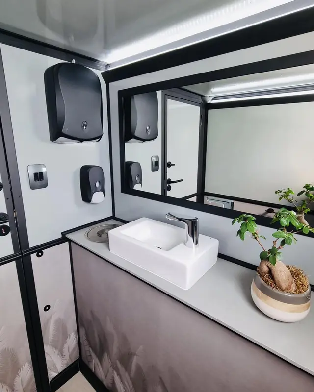 Restroom trailer sink, mirror and soap dispensers