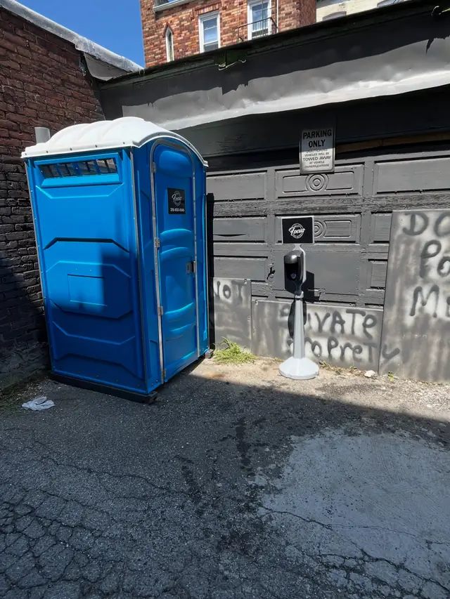Standard porta potty placed at a commercial site