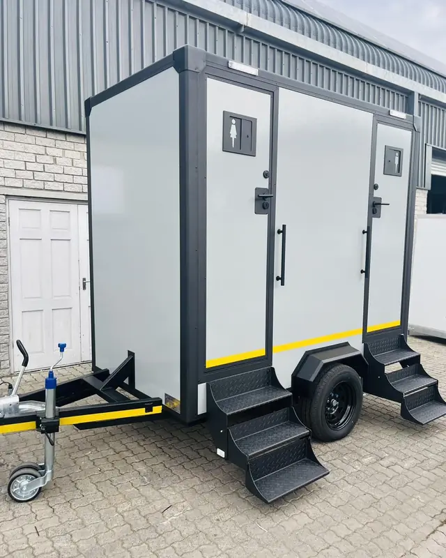 Two-stall restroom trailer with separate doors and steps